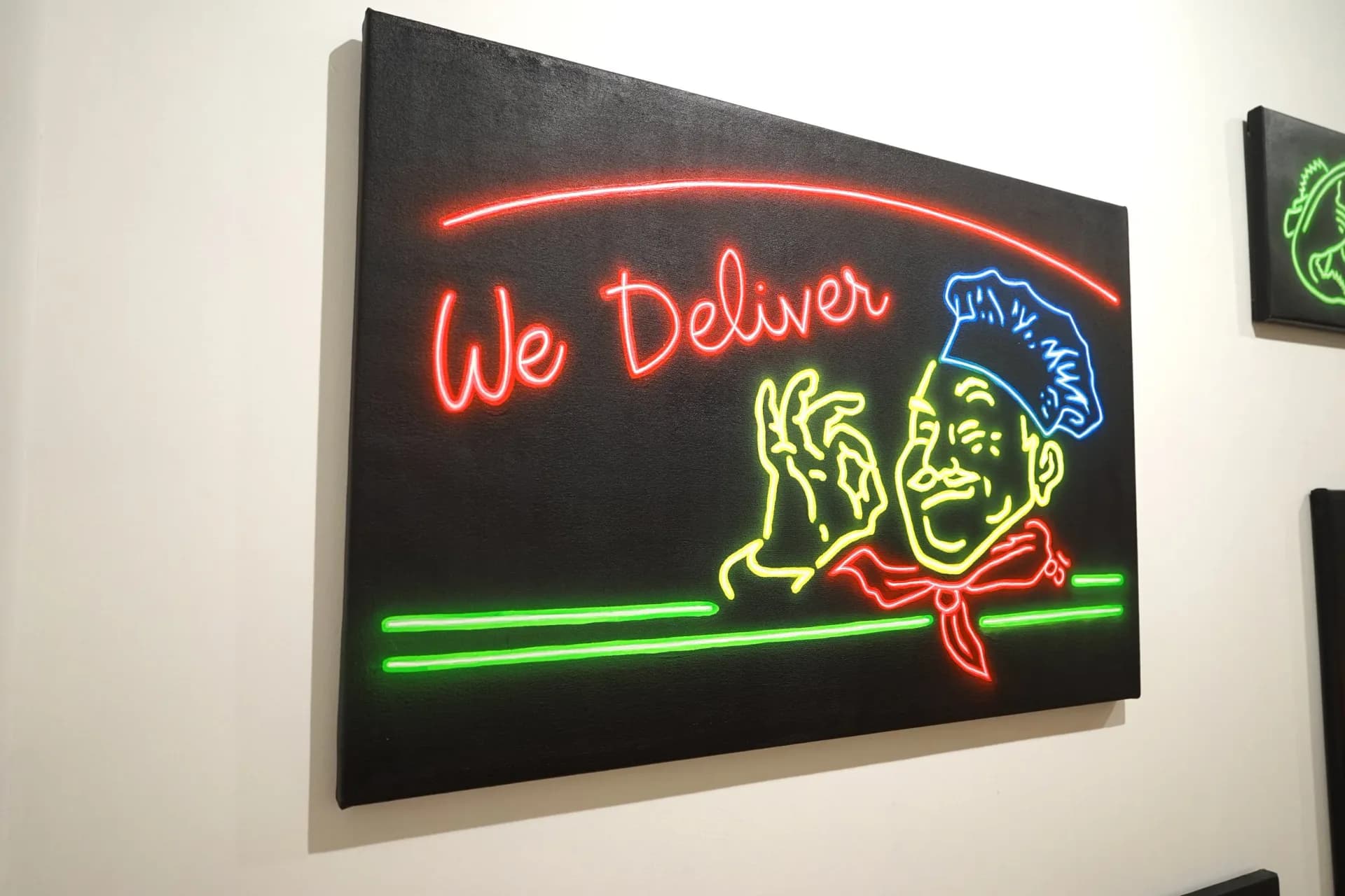 Neon-style painted canvas depicting a pizza delivery chef with glowing red, yellow, green and blue lines on black background