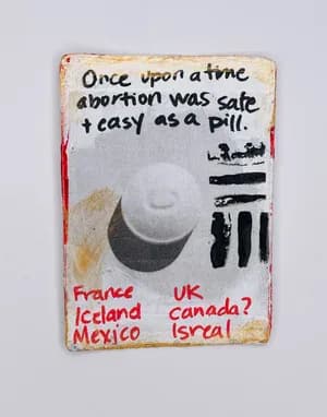 Mixed media card with abortion pill text, handwritten countries and stenciled imagery