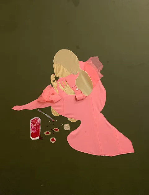 Fabric collage of a figure in pink robe hunched over scattered objects on dark green background