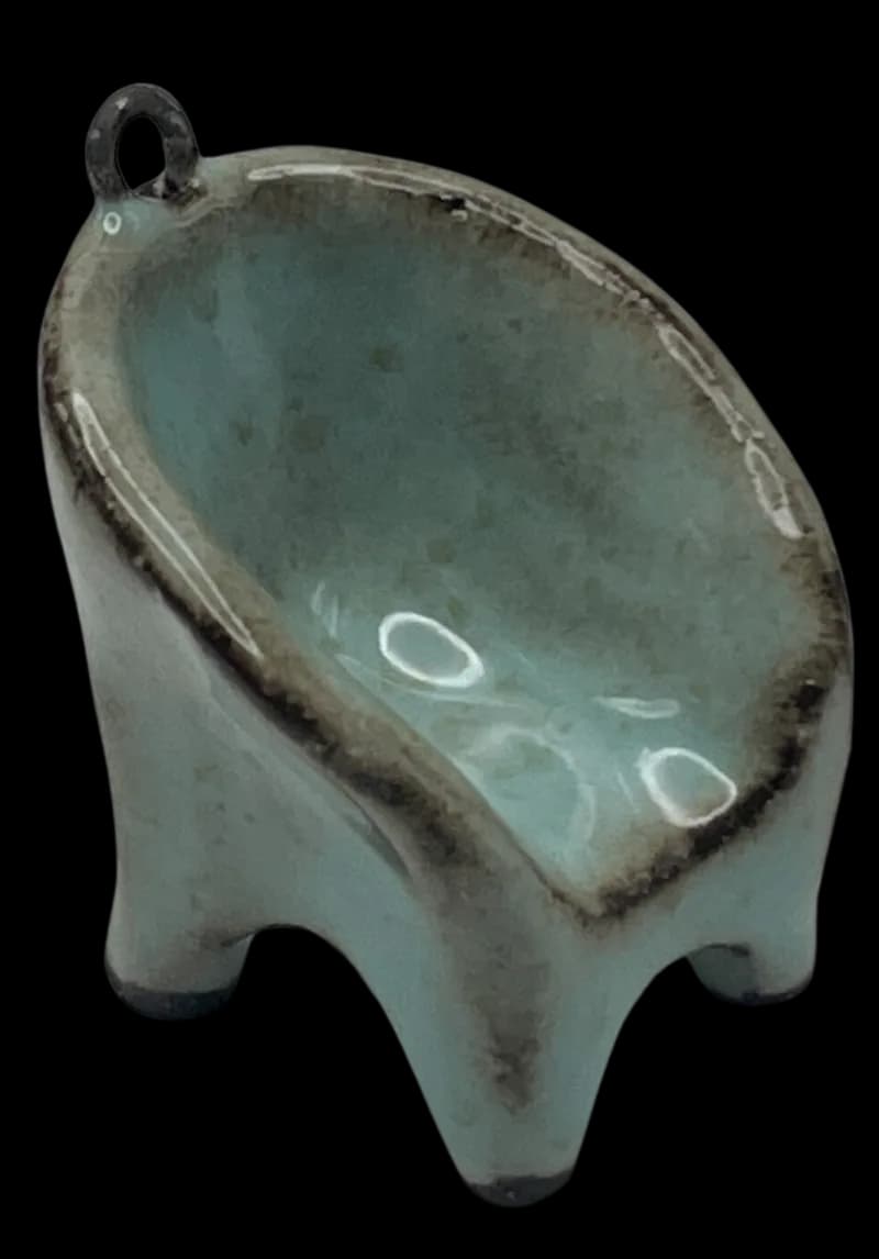 Teal glazed miniature ceramic chair pendant on black background