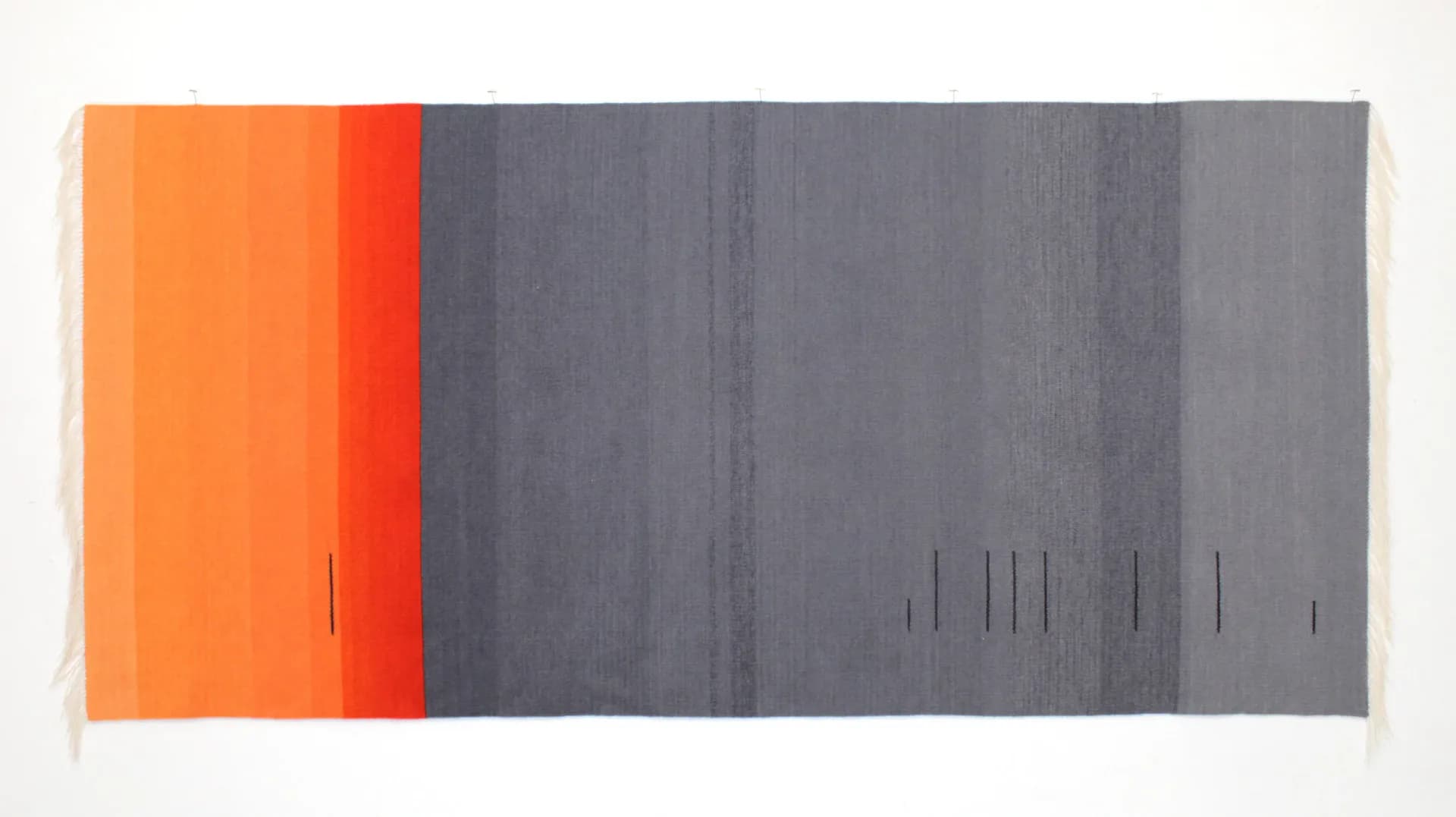 Woven tapestry with orange-to-red and grey color field bands and small vertical marks