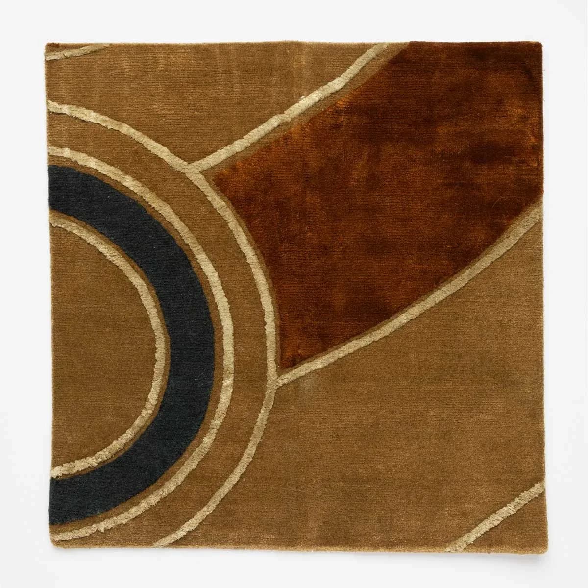 Abstract rug with circular and diagonal forms in camel, navy, and rust