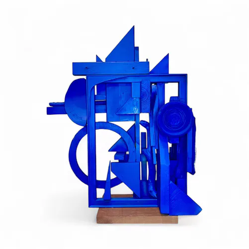 Abstract blue painted wood sculpture with geometric forms on a base