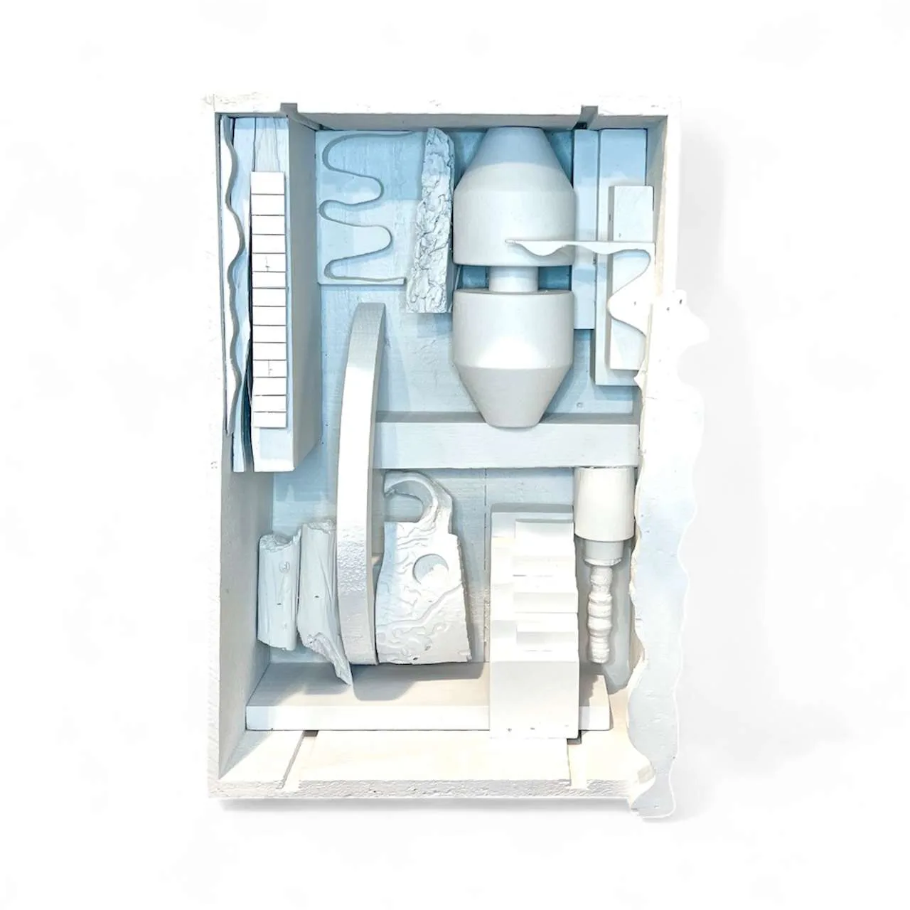 Overhead view of white ceramic or porcelain sculptural assembly with organic rounded forms and tube-like elements arranged in a grid-like composition.