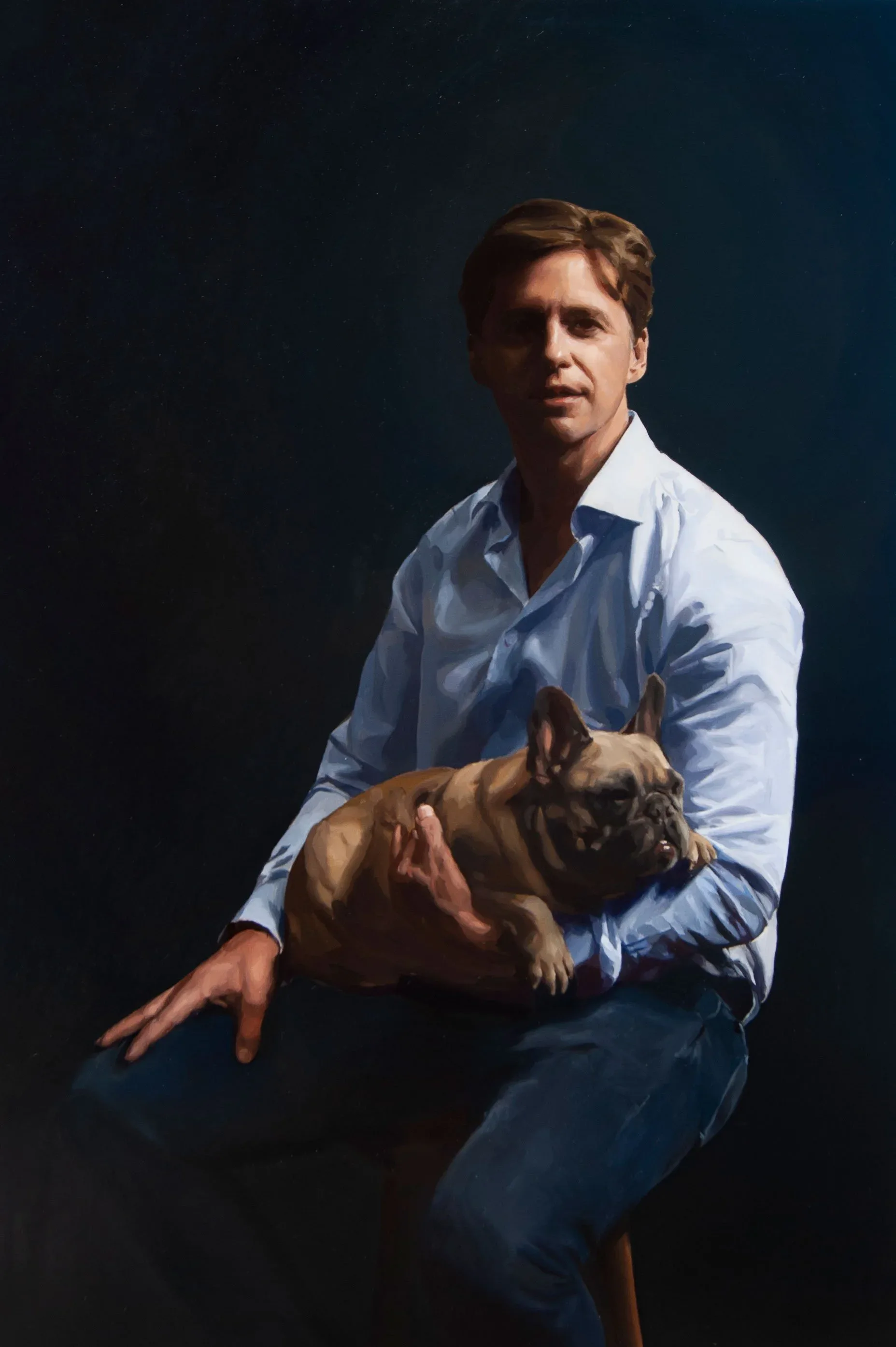 Oil painting of a man in a white shirt seated with a French bulldog against a dark background