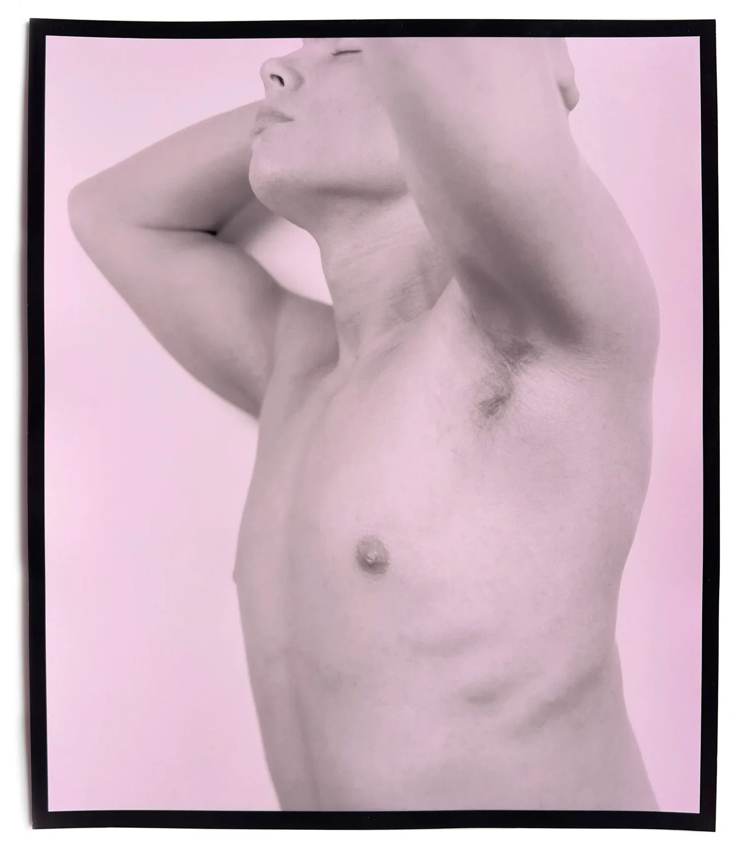 Black-framed portrait of a shirtless figure with arm raised, pale skin against soft pink background.
