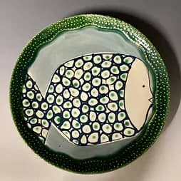 Ceramic plate with fish motif in green and white