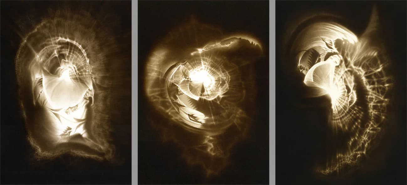 Triptych of luminous drawings or prints in gold and cream tones showing three variations of abstract spiral or embryonic forms against dark backgrounds.