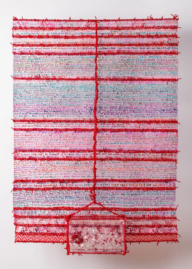 The Emperor's New Clothes large woven textile with dense hand-written text, red yarn, and embedded transparent element
