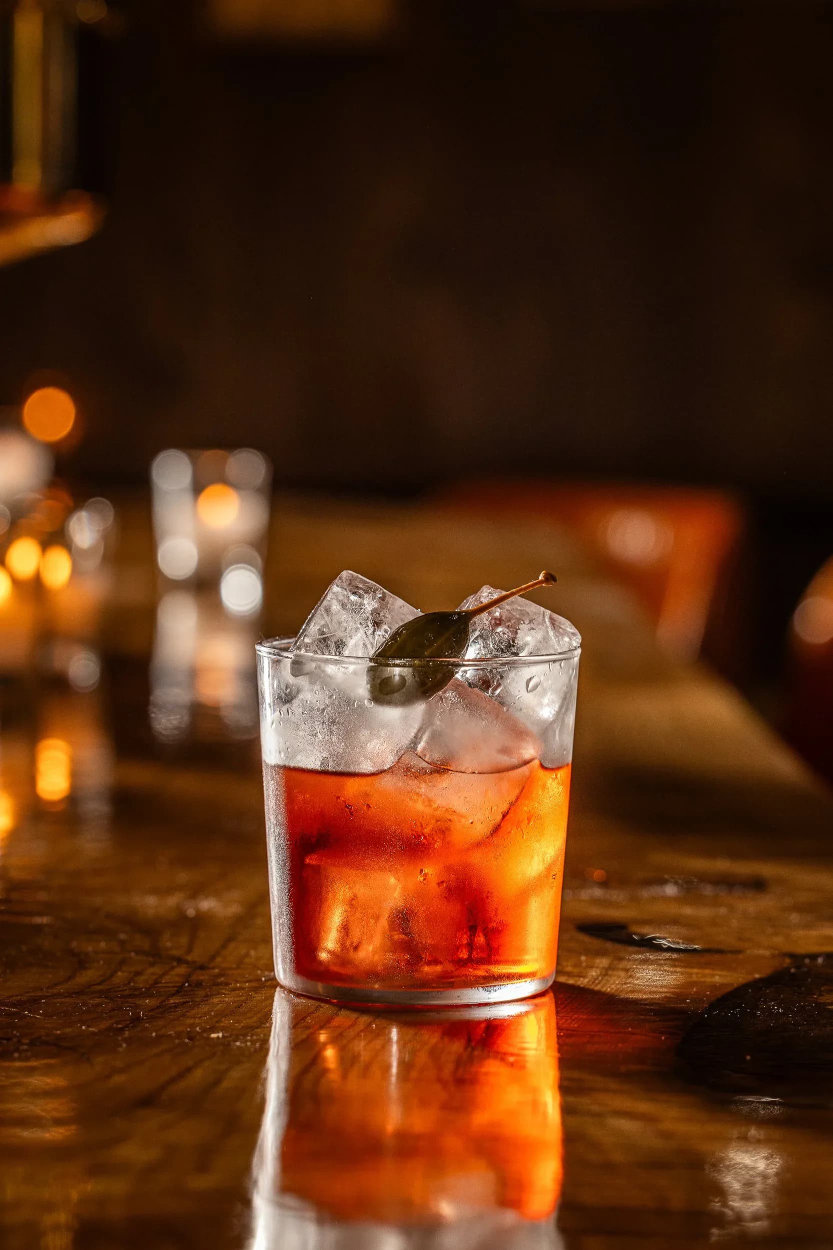 Frosted martini cocktail with smoked garnish served in an ornate brass jewelry box on marble surface