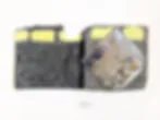 Abstract mixed-media composition with dark gray and yellow-green tones, featuring geometric and organic shapes layered together.