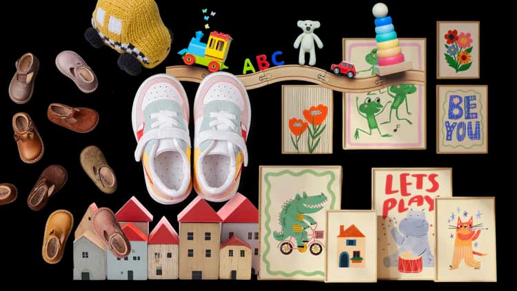 Flat-lay product collection including children's shoes, wooden houses, toys, and illustrated art prints.