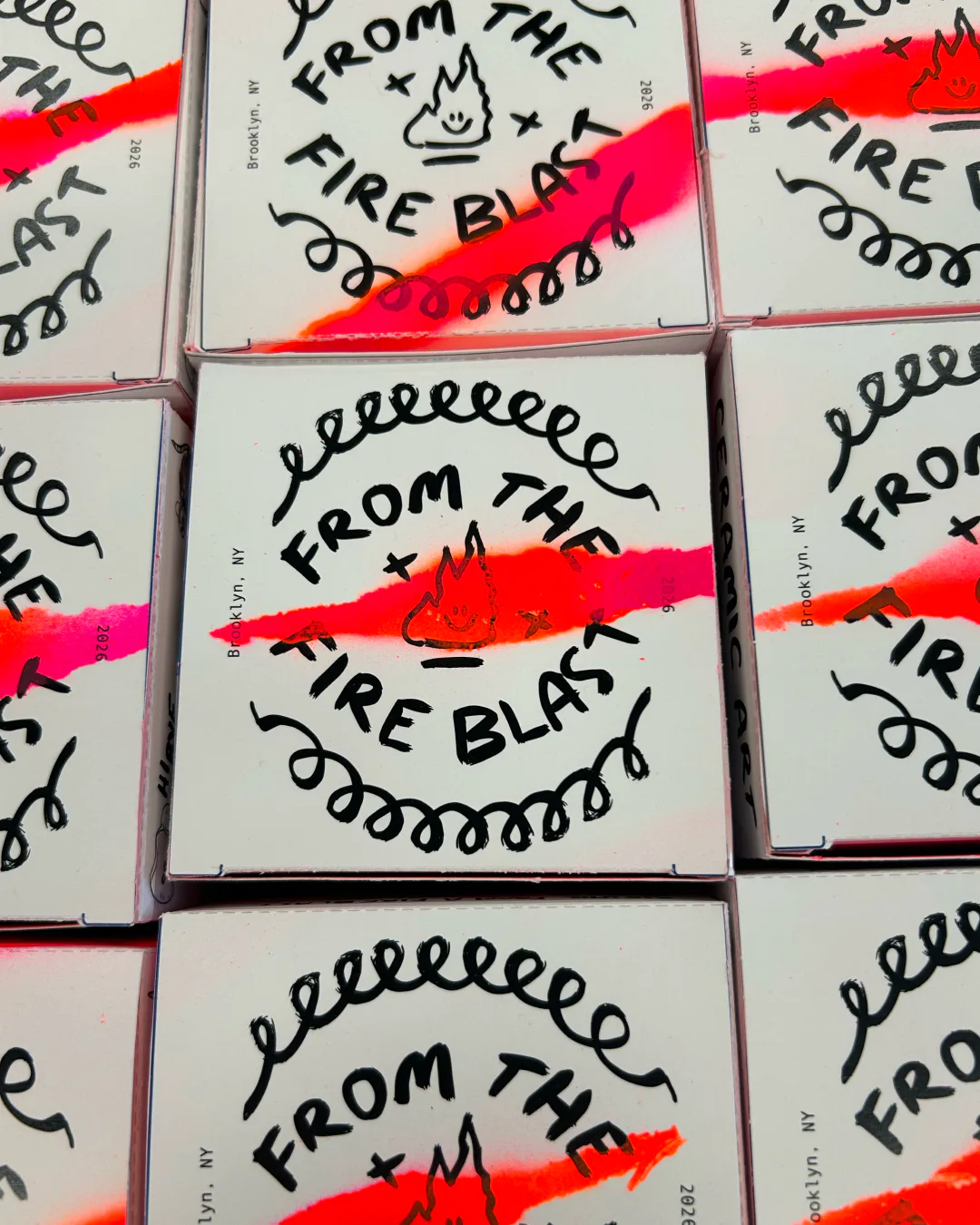 White CD cases with hand-drawn black text reading 'FROM THE FIRE BLAST' and flame illustrations, sealed with bright neon pink tape.