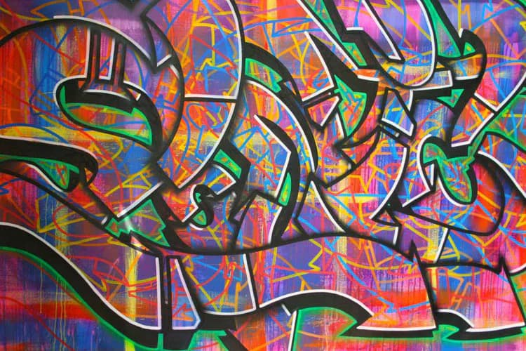 Vibrant graffiti mural by Sonic Bad featuring interlocking abstract letters with bold green outlines against a colorful background of reds, blues, yellows, and pinks.