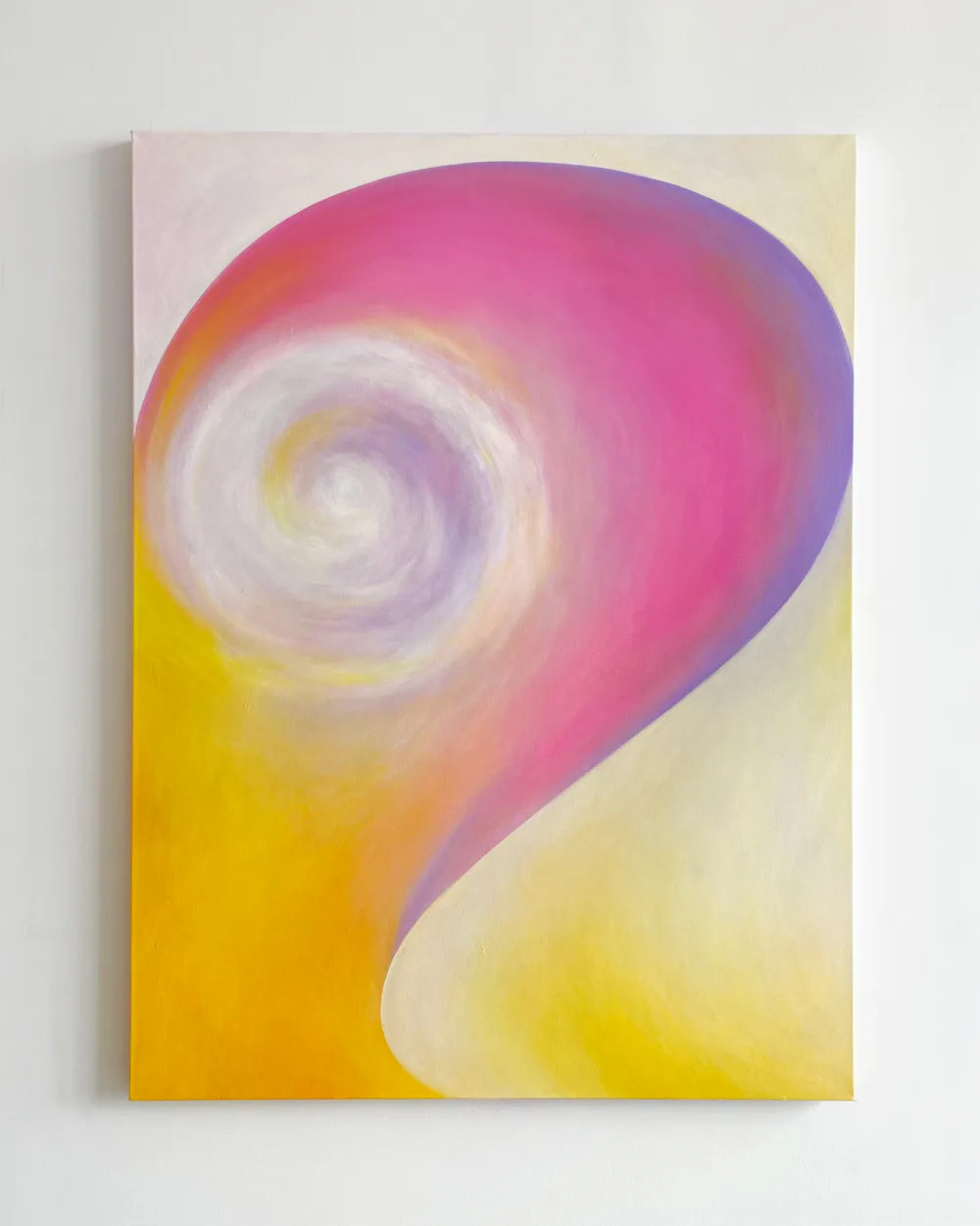 Abstract painting with vibrant pink, yellow, and purple swirling spiral form on canvas
