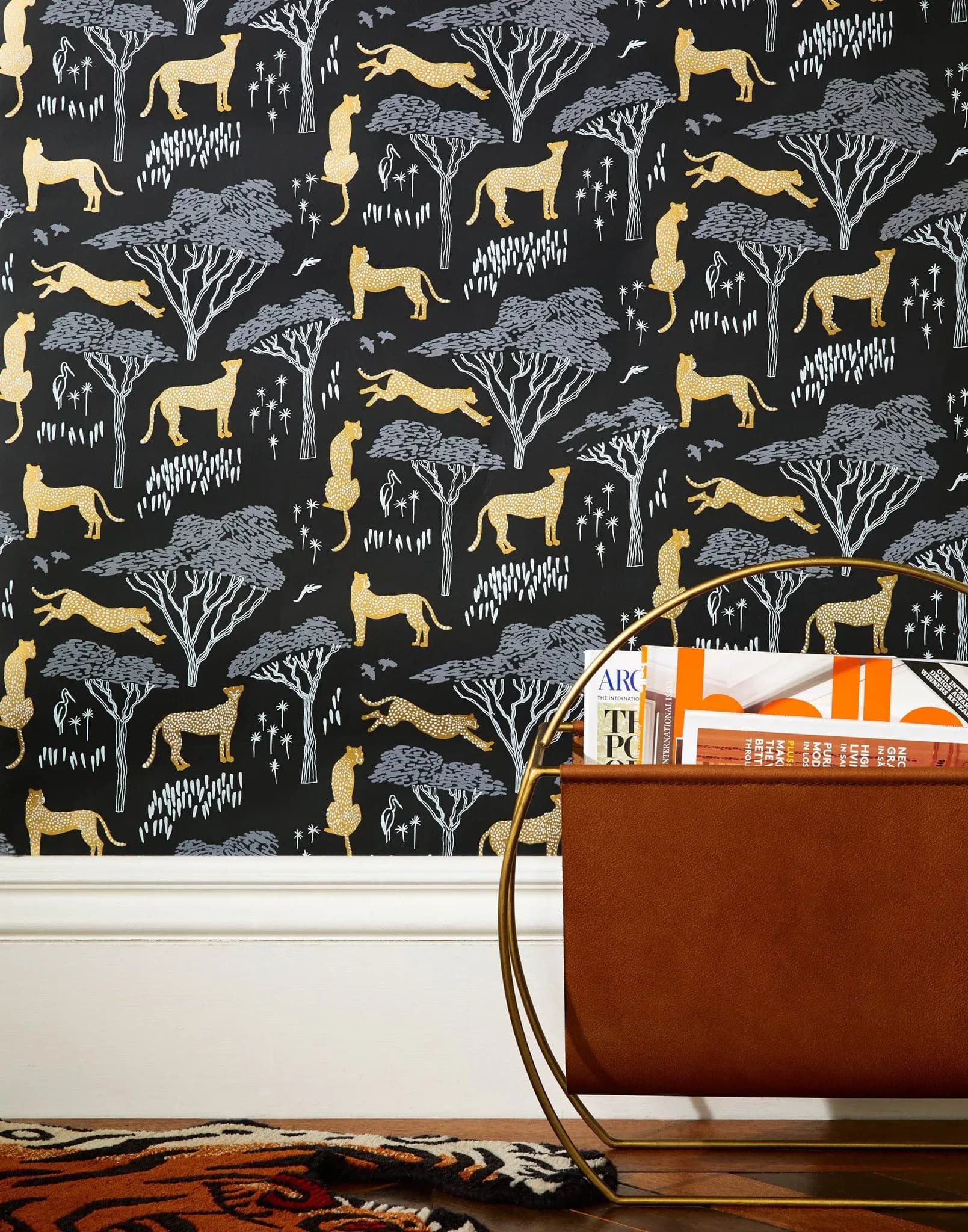 Dark Serengeti cheetah wallpaper installed in room with magazine rack