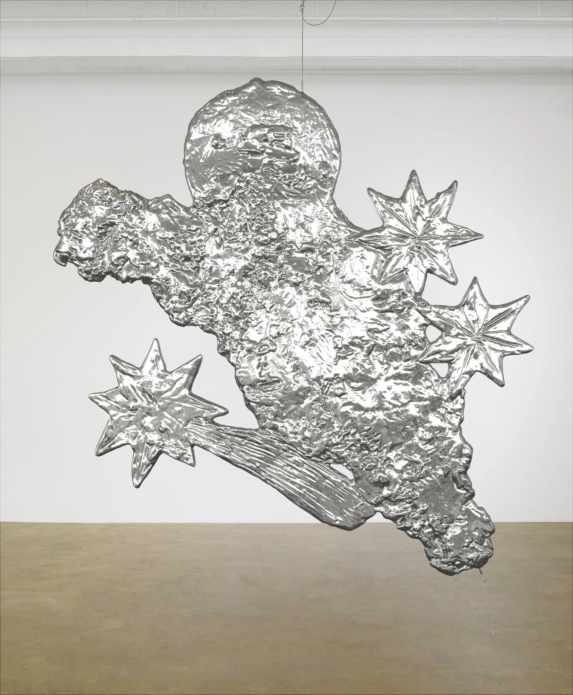 Large crumpled silver metallic suspended sculpture with protruding crystalline star shapes, resembling an abstract celestial form.