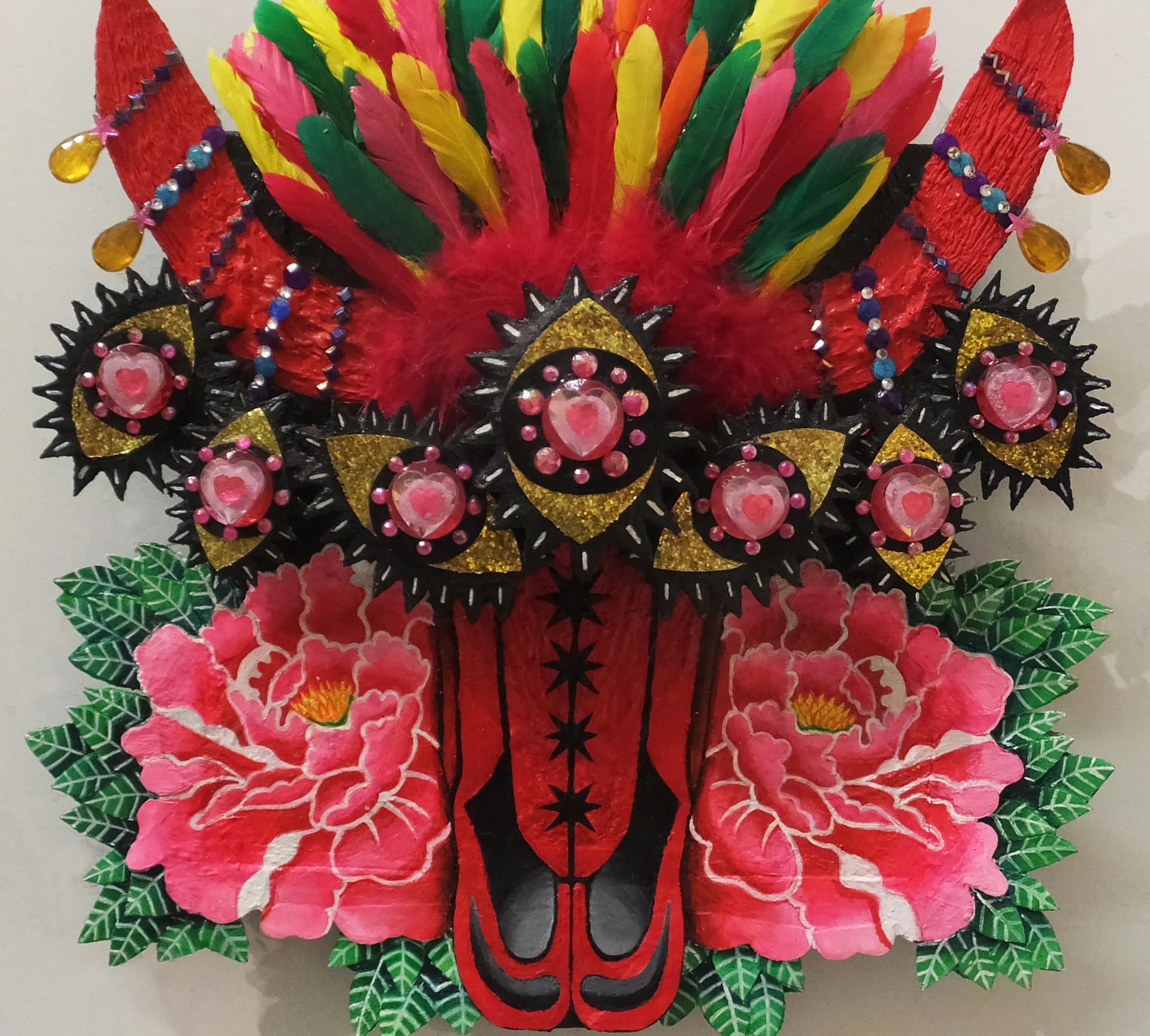 Ornate mixed-media mask with feathers, jewels, painted peonies and multiple eyes