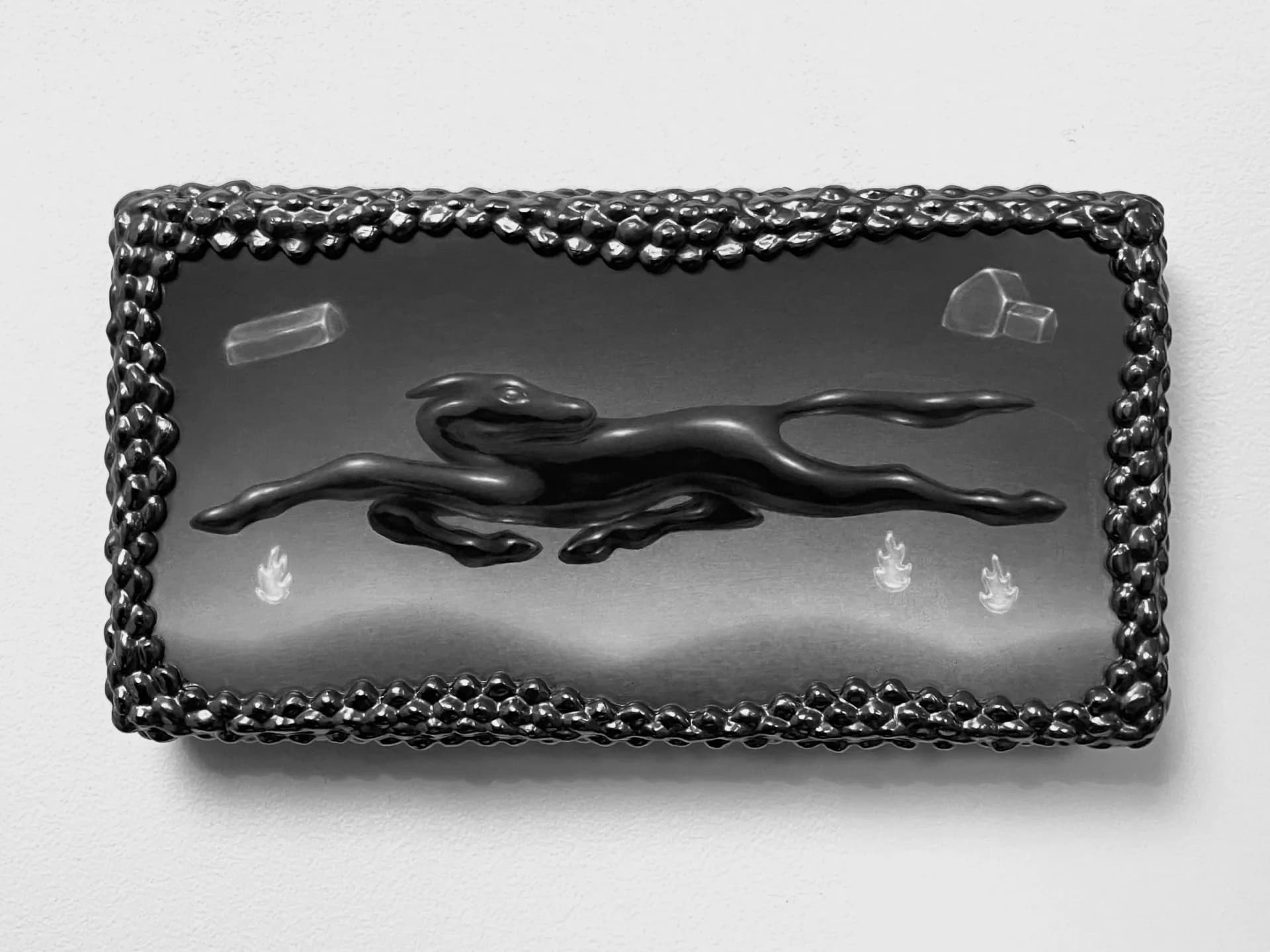 Rectangular wall-mounted sculptural painting of a leaping black animal with bubble-textured frame, flames and crystals