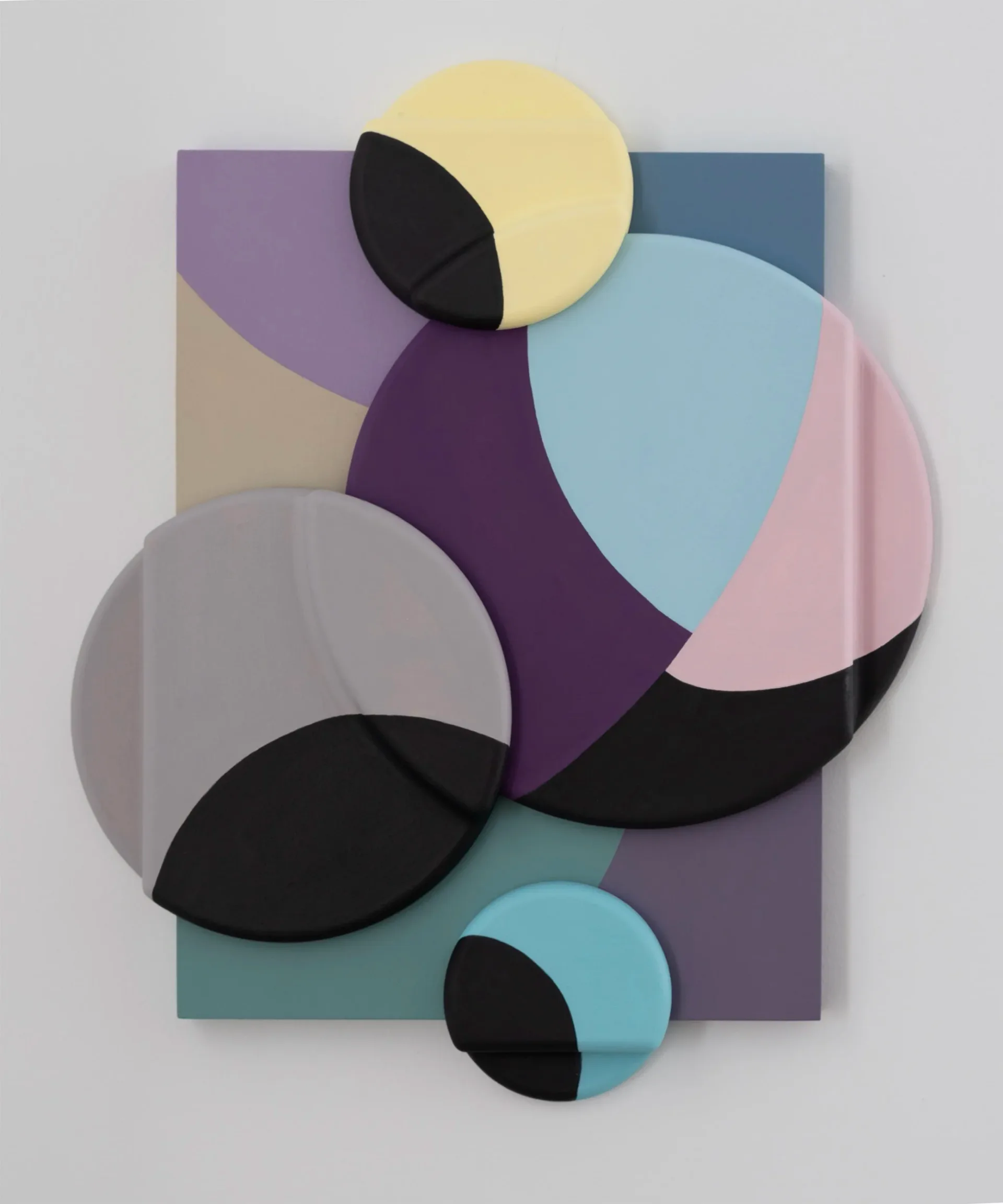 Abstract wall relief with overlapping circular forms in pastel purples, yellows, blues and pinks on a layered painted ground