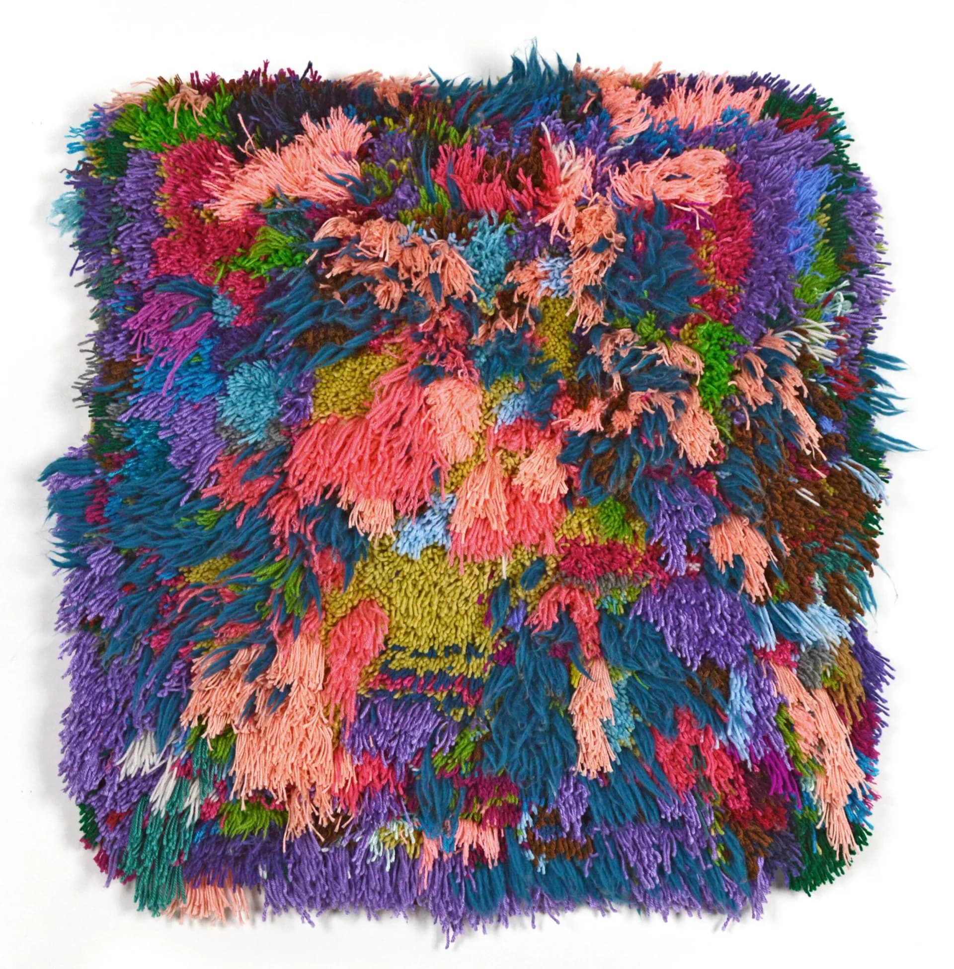 Textured textile or fiber art with vibrant multicolored spiky/furry surface in pink, purple, blue, green, and orange.