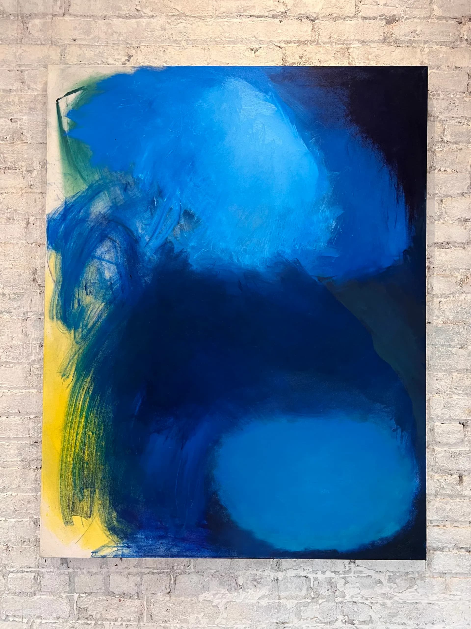 Abstract painting in deep blues and yellows with luminous circular forms