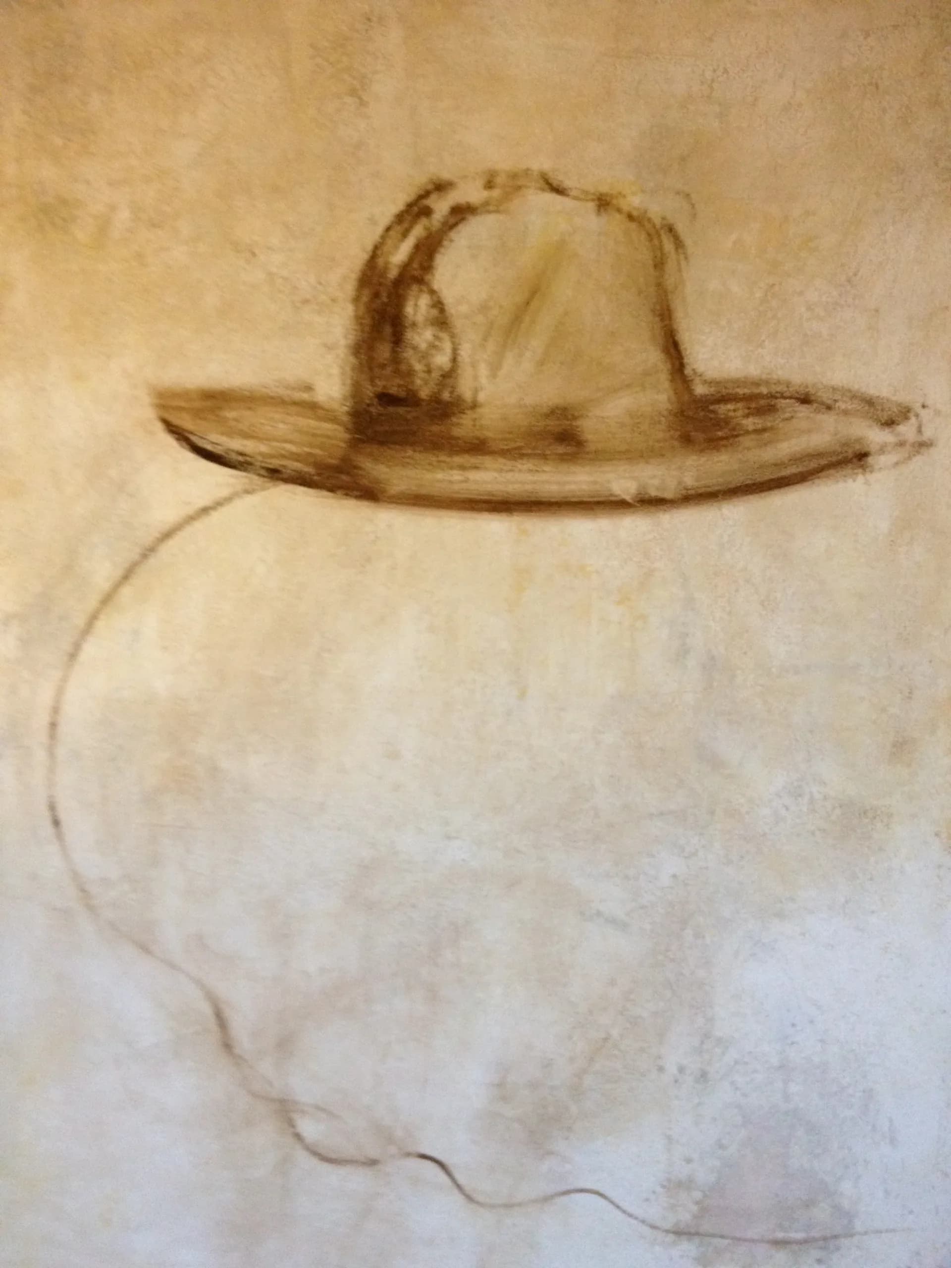 Sepia-toned drawing of a wide-brimmed hat floating above a spherical form, sketched with delicate linear marks on cream paper.