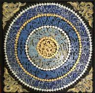 Ornate square composition with concentric circular patterns in gold, blue, and white with decorative corner elements on dark background.