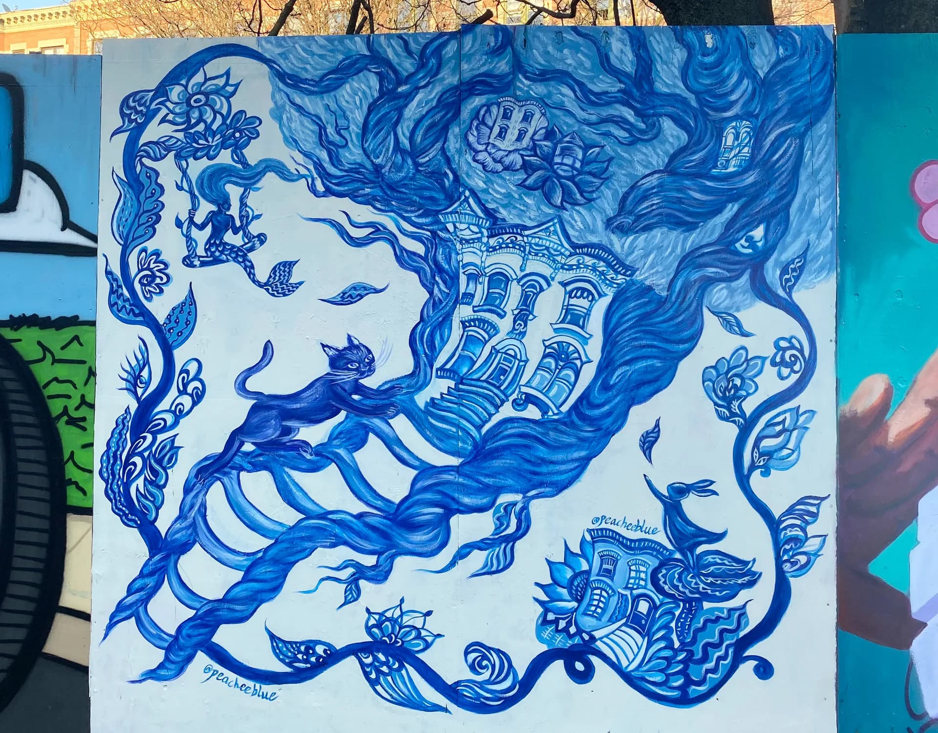 Street mural of pigeons in streetwear playing mahjong on a yellow background with NYC tenement buildings