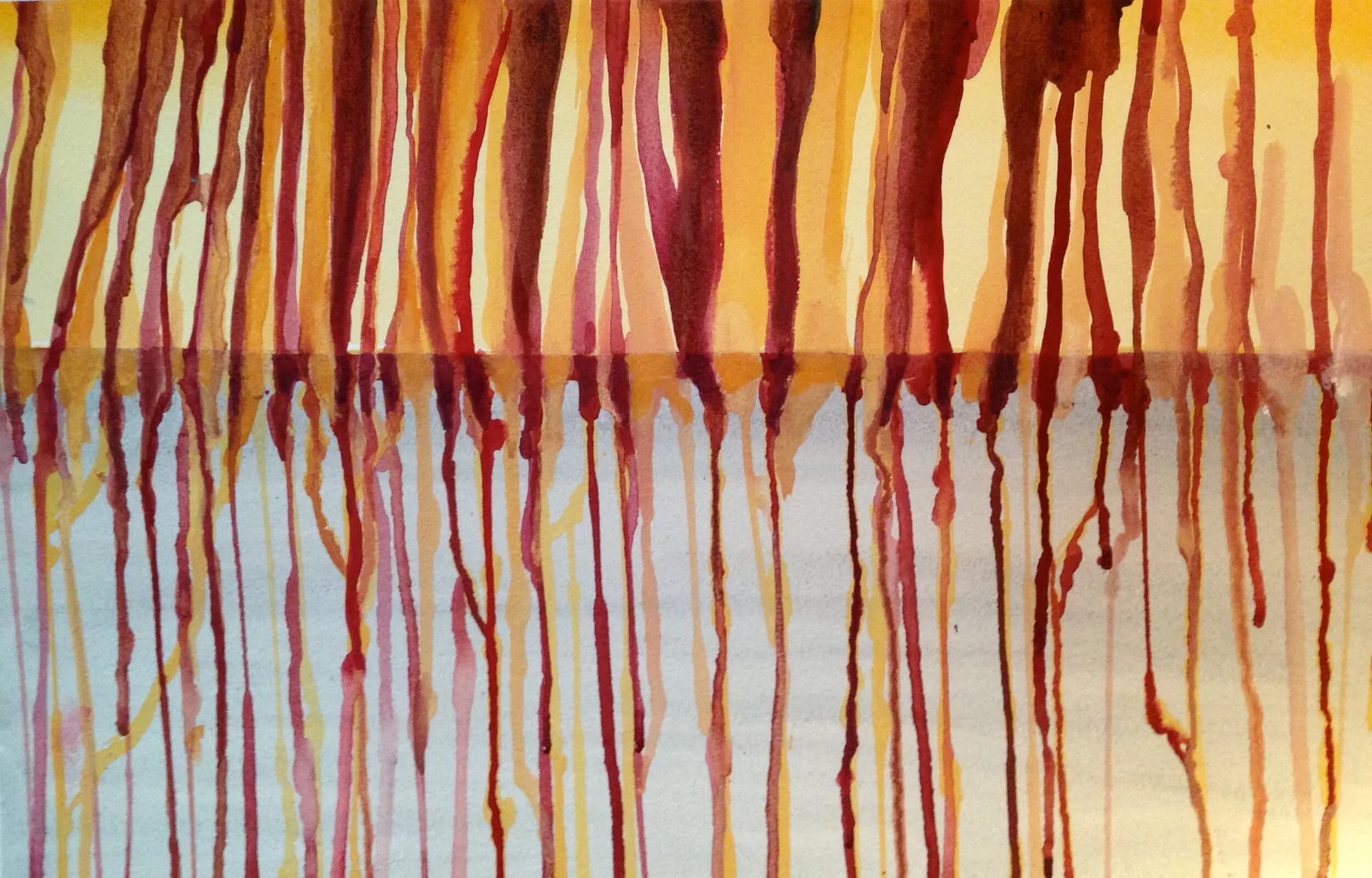 Watercolor painting of warm amber and crimson drips against a cool grey wash, evoking autumn reflections