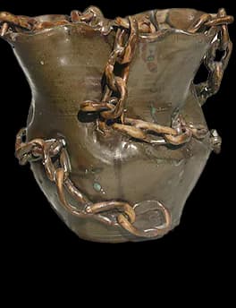 Ceramic vessel with sculpted clay chain draped around it, earthy brown glaze