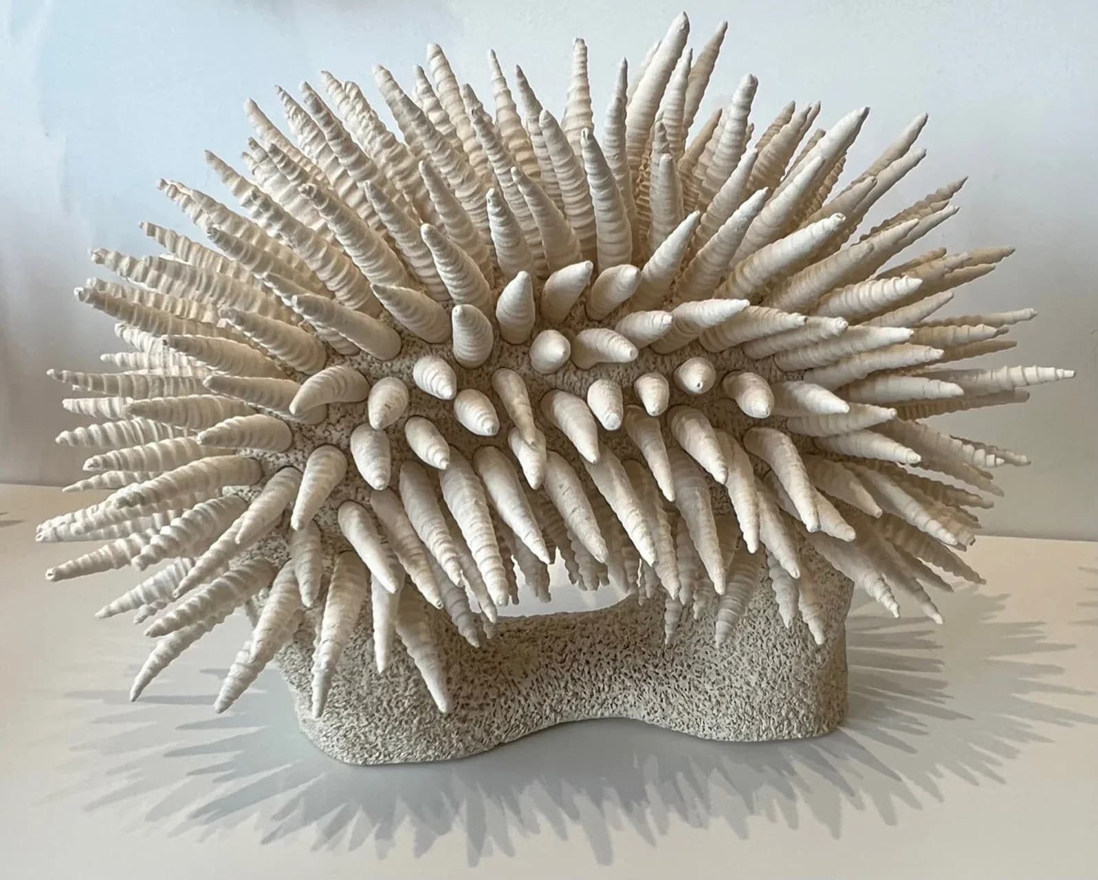 Large freestanding ceramic sculpture of coral-like arch form with spiraling shell-shaped spines