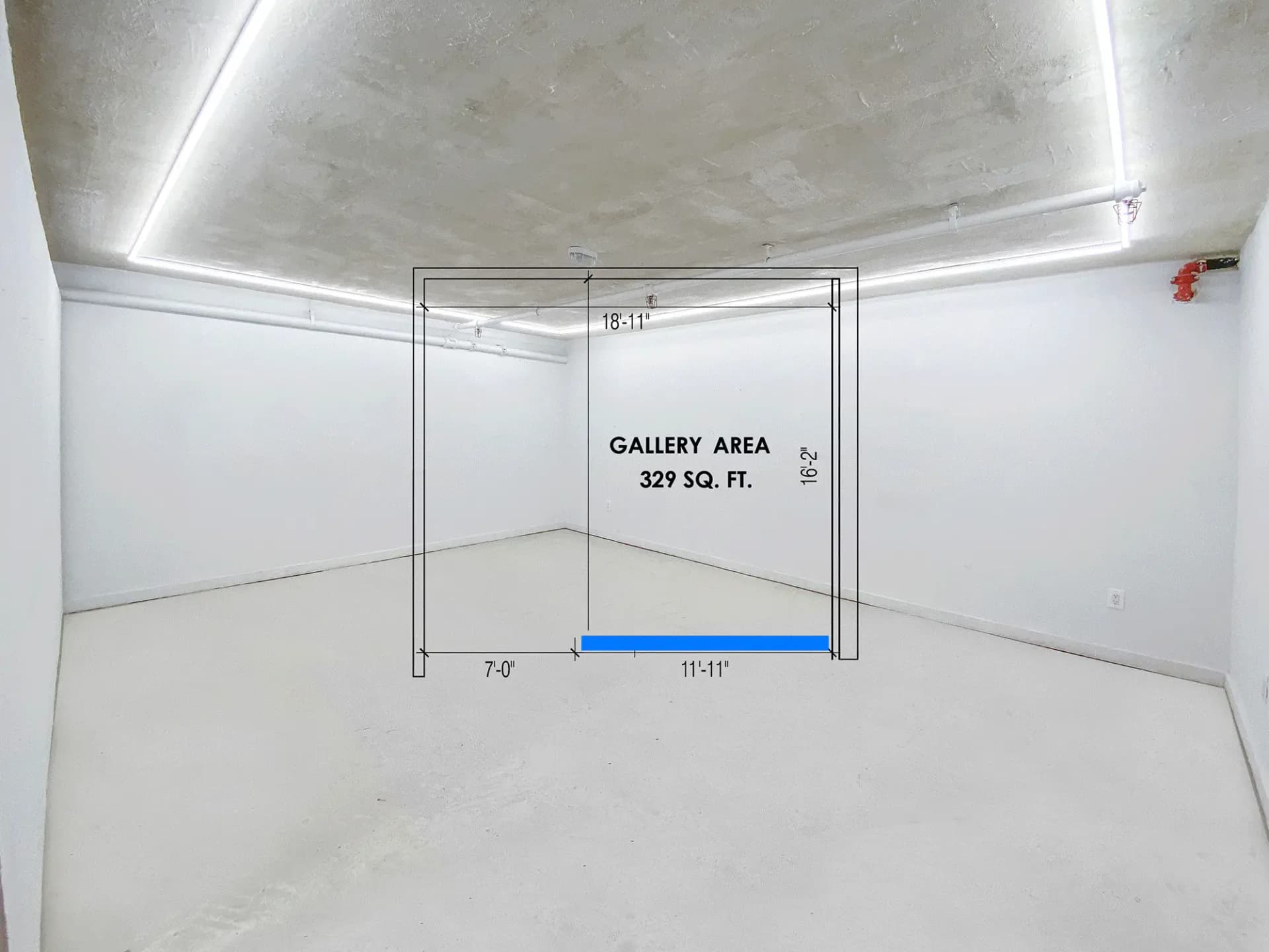 Empty white gallery space with polished concrete floor, labeled "GALLERY AREA 329 SQ. FT." and overhead linear lighting.
