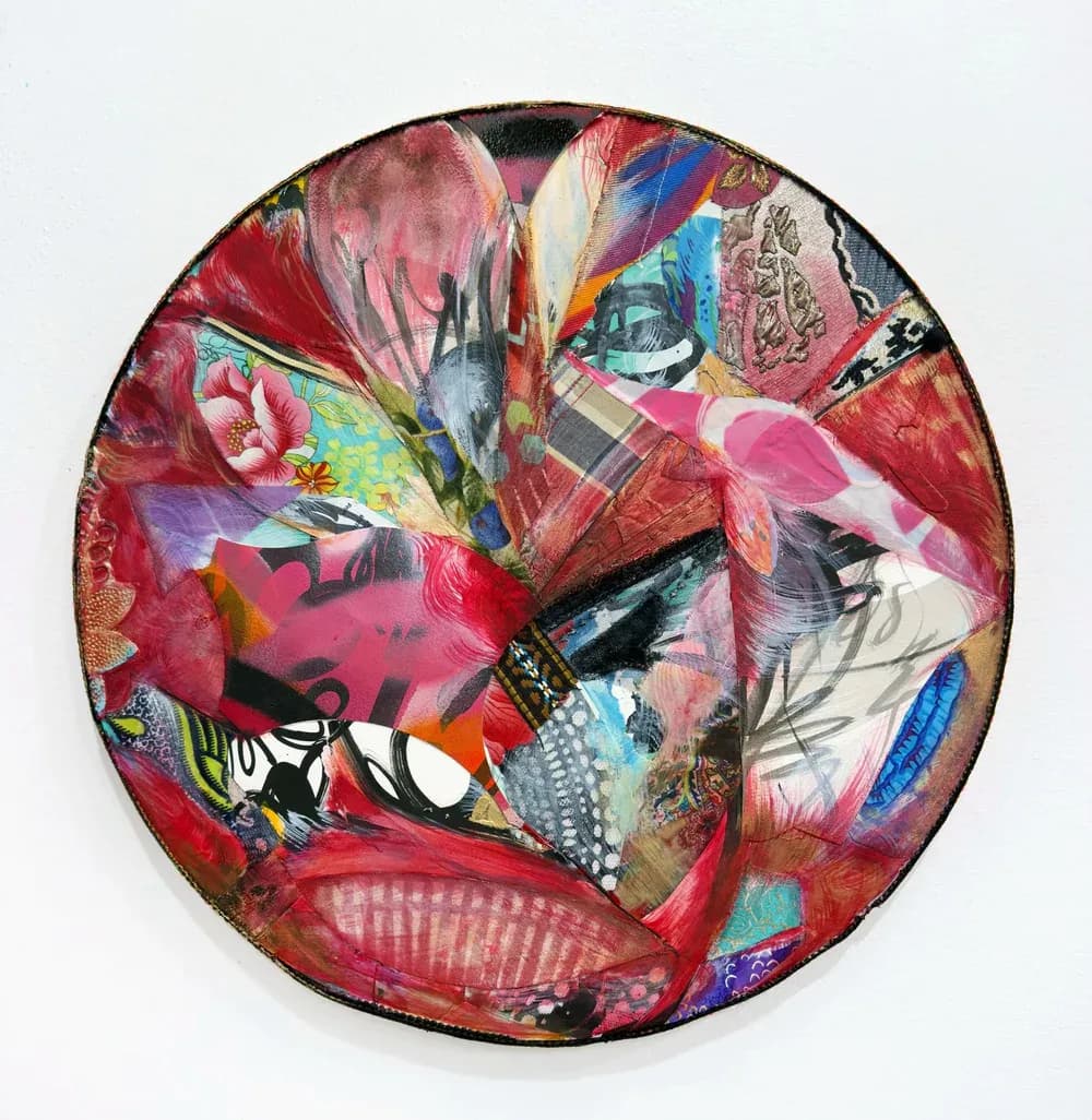 Circular mixed-media collage painting with vibrant reds, pinks, and patterns on round canvas