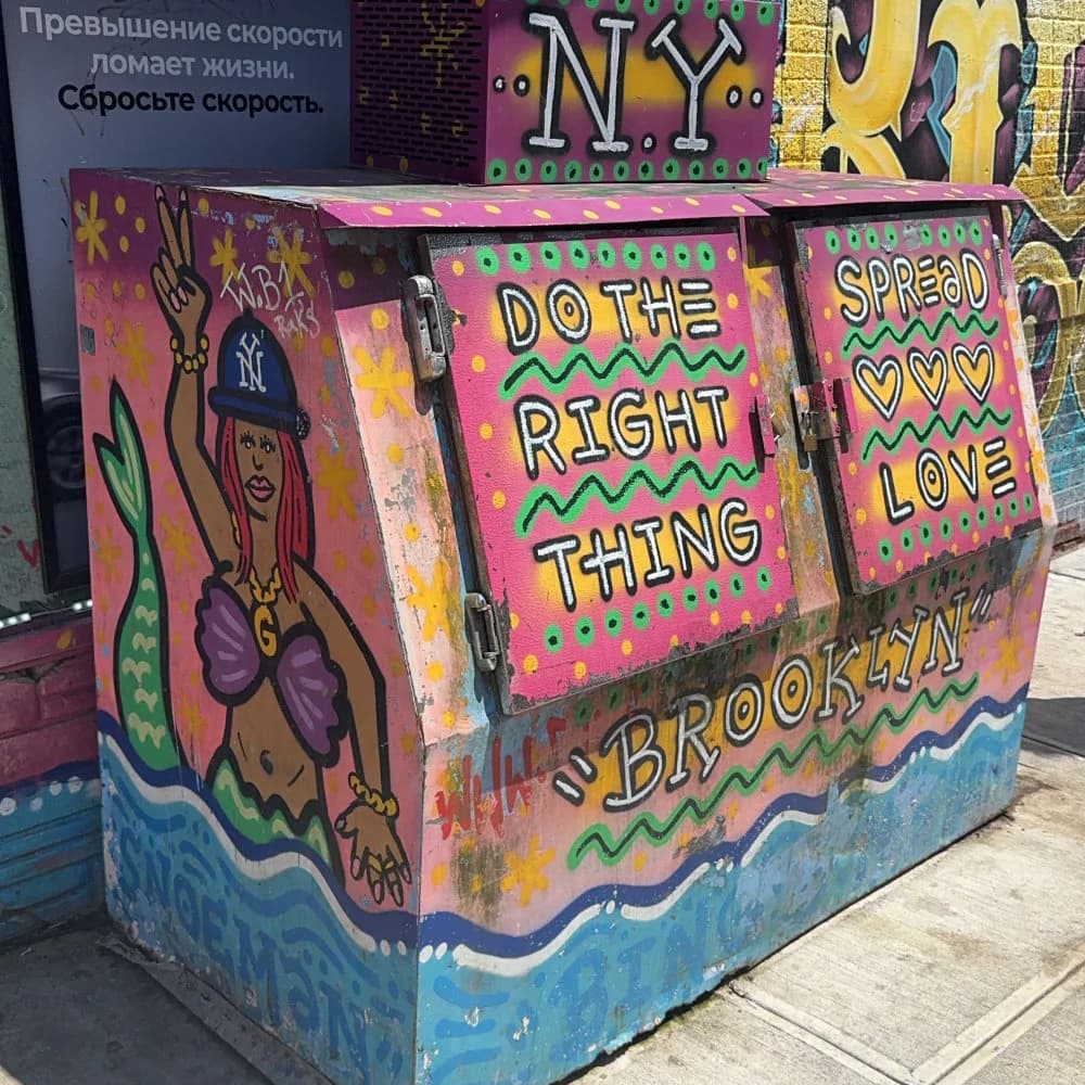 Colorful 3D sculptural artwork with 'Do The Right Thing' and 'Brooklyn' text, featuring neon pink, purple, yellow background with stylized figures.