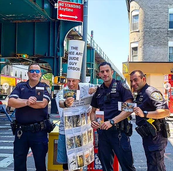 Free Art Dude Guy Person performance art with NYPD officers holding free art postcards in Woodhaven, Queens
