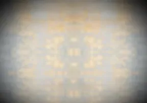 Abstract composition with muted gold and cream tones creating a soft, ethereal circular form against a darkened background.
