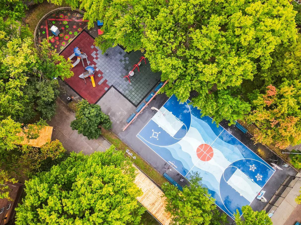 Aerial view of a colorfully painted basketball court and playground