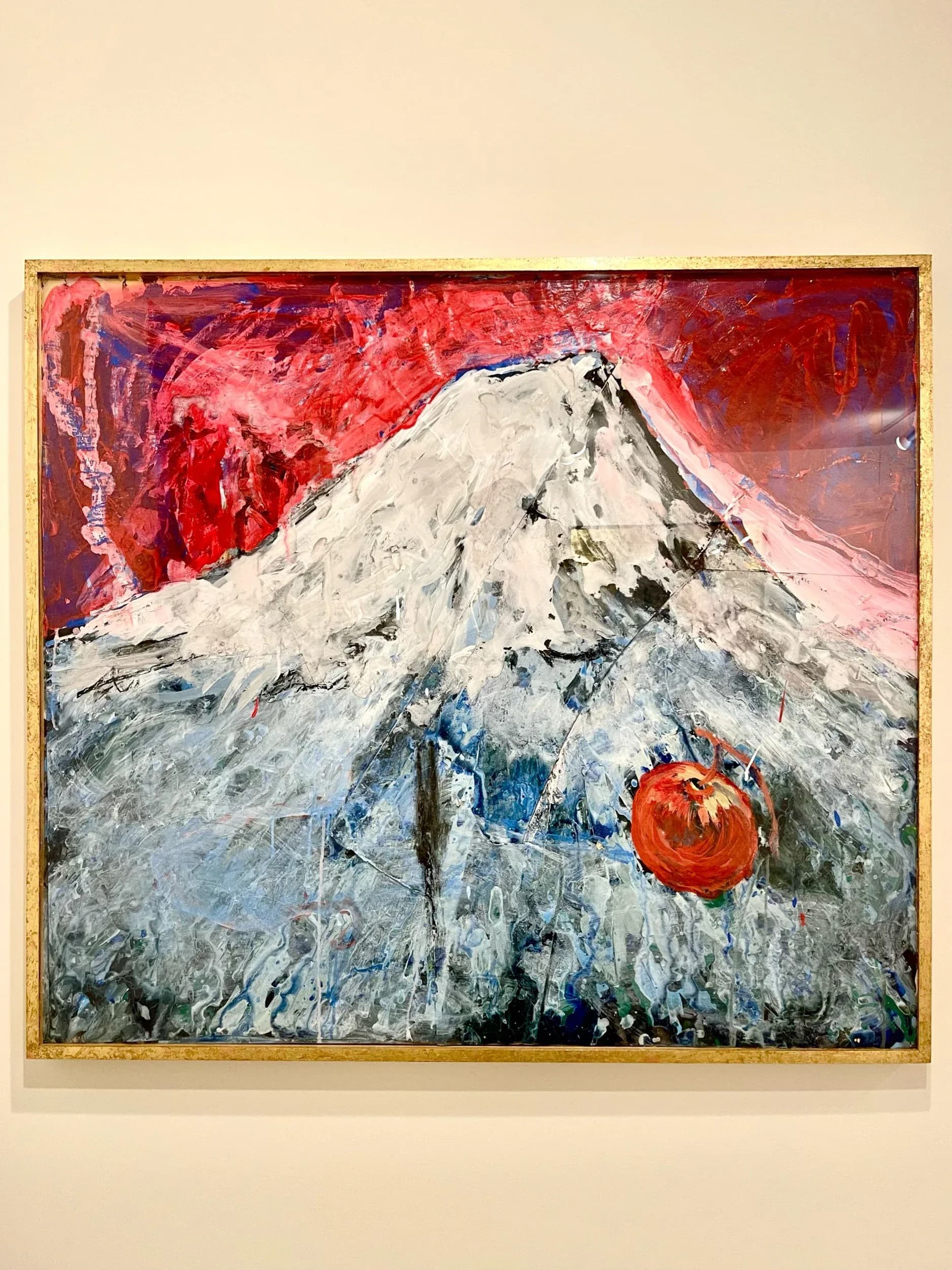 Expressive painting of Mount Fuji with red and white snow cap on crimson background with red apple motif