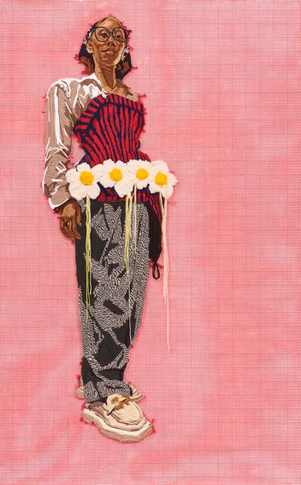 Embroidered portrait of a figure wearing glasses and red corset against pink background, holding white daisies with yellow centers.