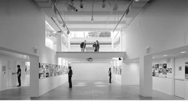Minimalist white gallery interior with high ceilings, skylights, white walls displaying architectural drawings or exhibitions, figures walking through space.