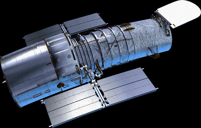 Model of the Hubble Space Telescope with blue cylindrical body, solar panels, and detailed instrumentation against white background.
