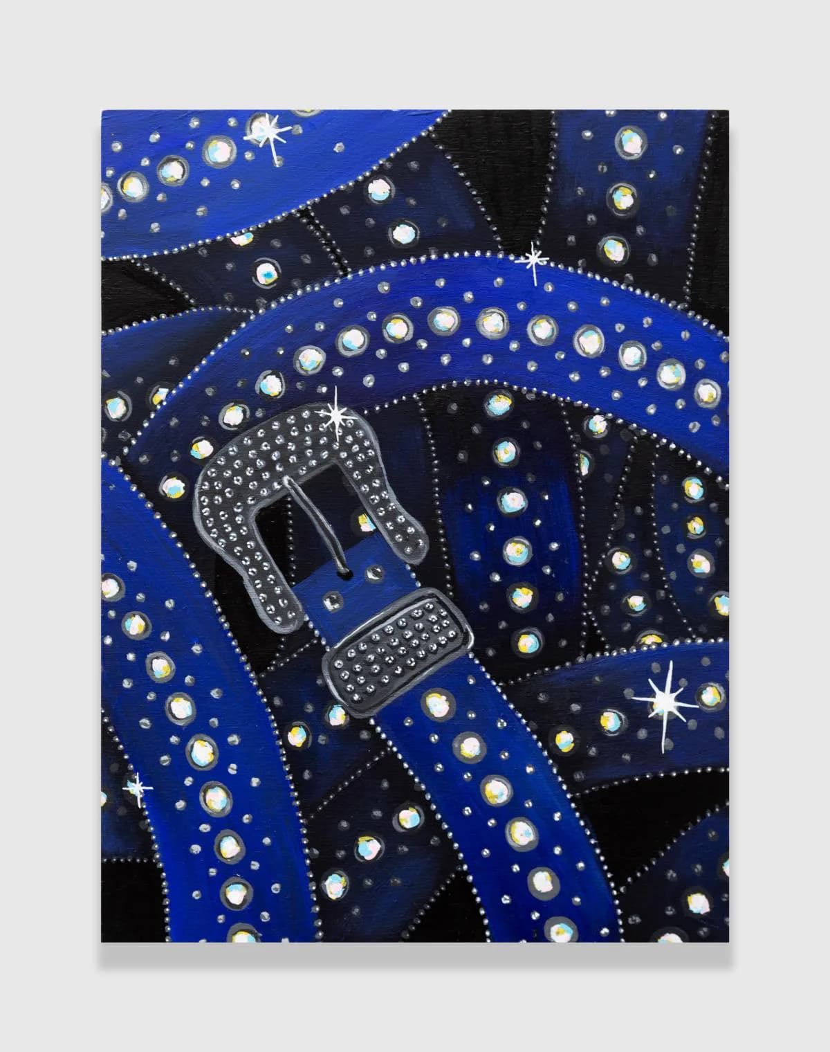 Painted composition with a studded belt buckle in white rhinestones centered within flowing blue and black sections decorated with pearl studs and white accents.
