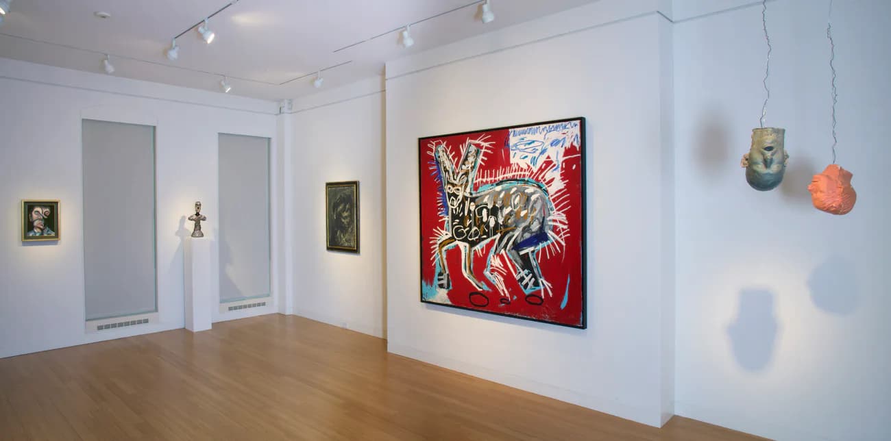Gallery space with white walls, wooden floors, large red and black expressionist painting, small framed works, and suspended sculptural objects.