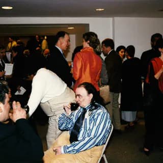 Crowded reception or opening event at Fountain House Gallery with multiple visitors in formal and casual attire.