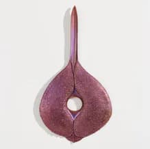 Three-dimensional sculptural form in deep mauve felt with a teardrop shape and central circular opening.