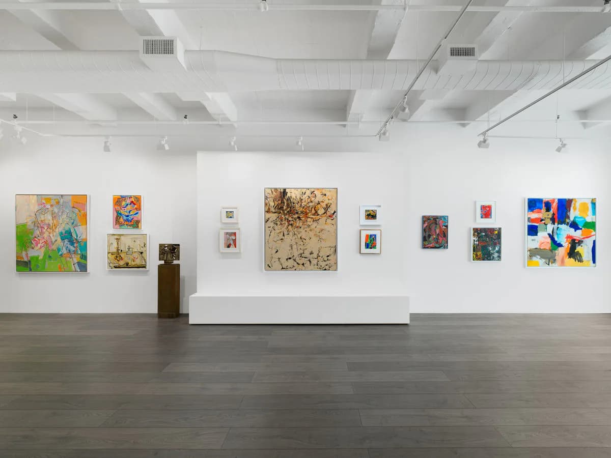 White gallery interior at Hollis Taggart with polished concrete floor and various colorful artworks displayed on white walls.