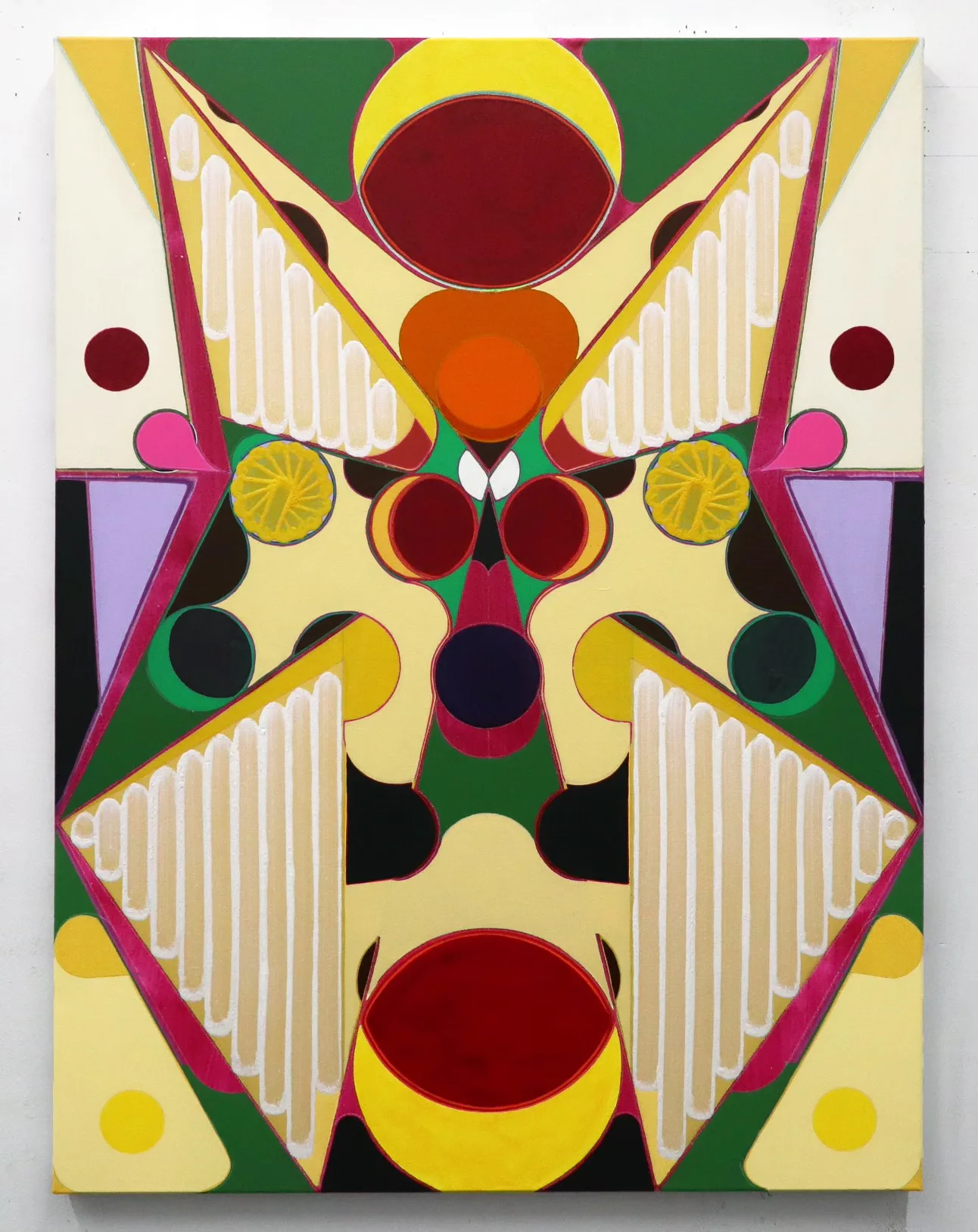 Symmetrical abstract painting with geometric shapes in yellow, green, magenta, and black, featuring circles, striped triangular forms, and mirrored composition on canvas.