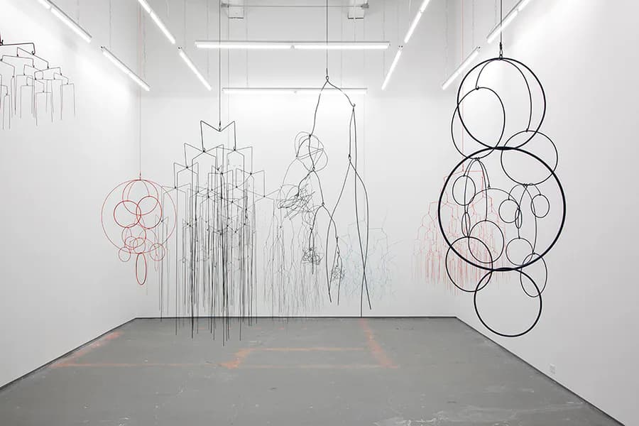 Gallery interior at Kate Werble Gallery showing white walls and ceiling with hanging wire and metal sculptural installations of various geometric and organic forms.