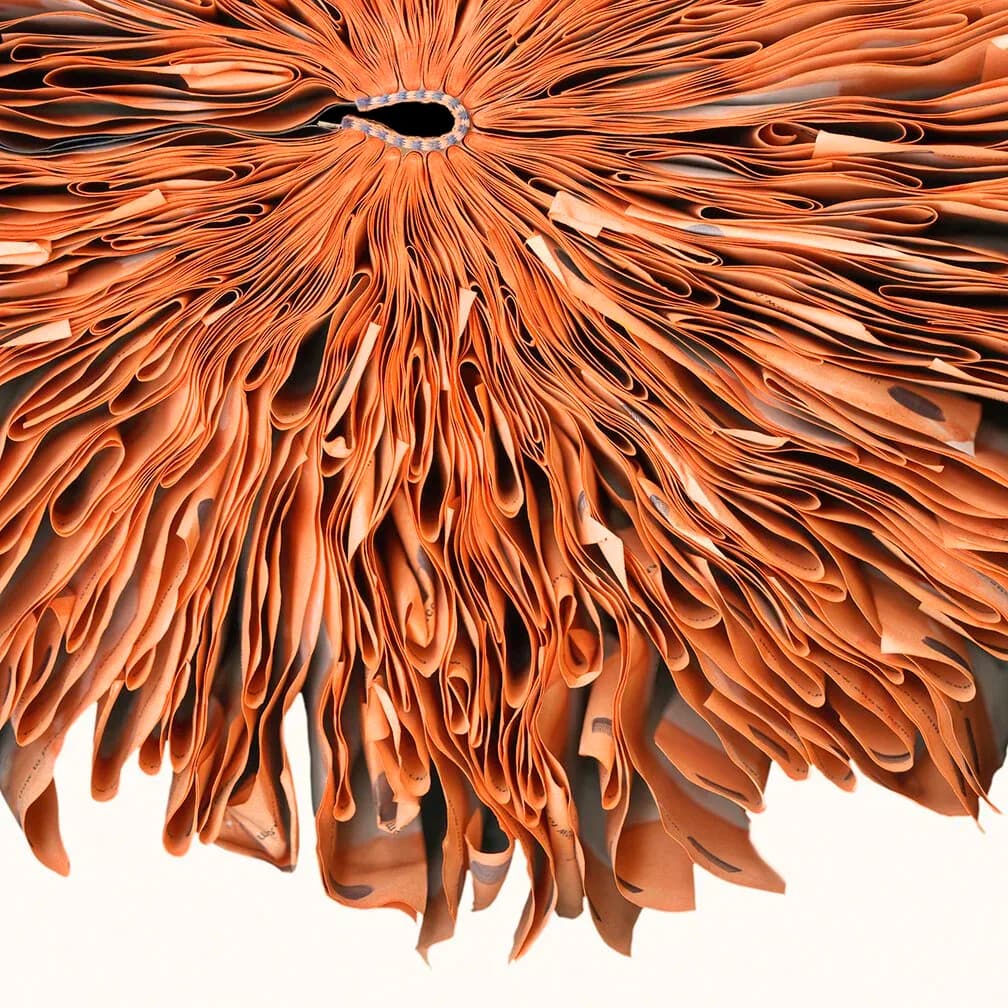 Abstract digital artwork with radiating copper and orange strands flowing outward from a central black void, resembling exploding energy or magnetic field lines.